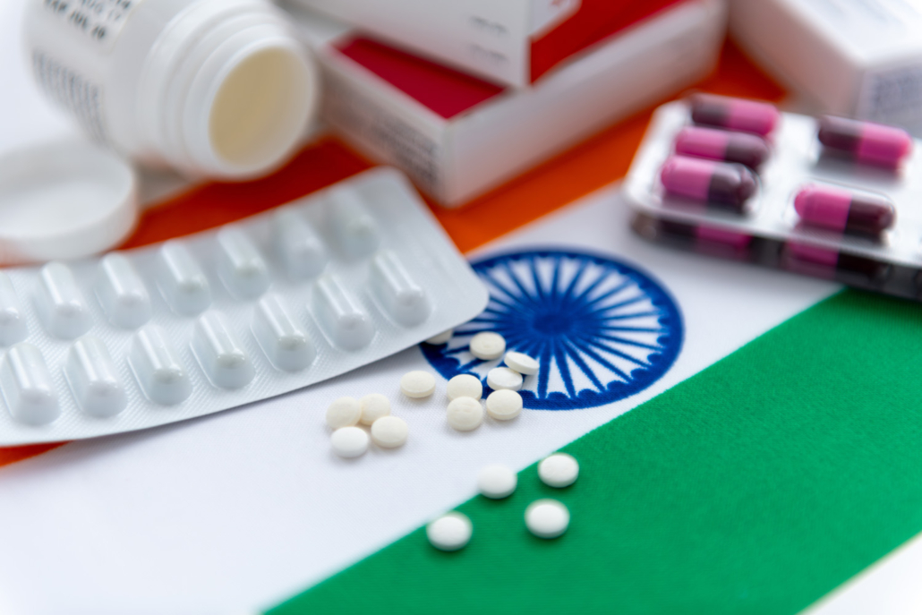 various packaged medications on top of an Indian flag